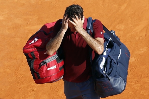 Roger Federer leaves the court frustrated after his loss in Monte Carlo. Photo: Valery Hache/AFP/Getty Images