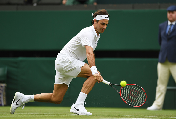 Federer reaches for a low backhand. Photo: Shaun Botterill/Getty Images