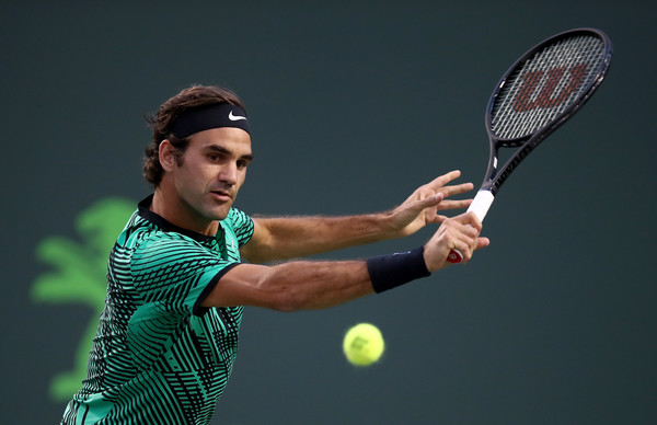 Federer slices a backhand during his semifinal match. Photo: Julian Finney/Getty Images