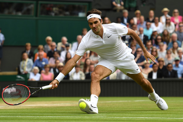 Federer lunges for a forehand on Friday at Wimbledon. Photo: Shaun Botterill/Getty Images