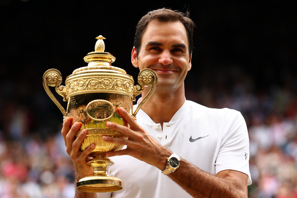 Federer holds his eighth Wimbledon trophy in July. Photo: Clive Brunskill/Getty Images