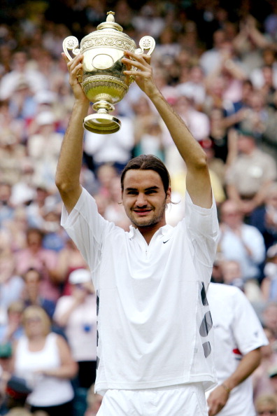Federer hoists his trophy after winning Wimbledon in 2003. Photo: Cynthia Lum/WireImage