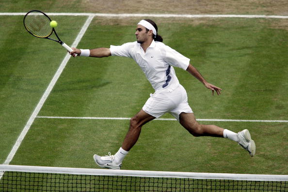 Federer lunges for a volley during his semifinal win. Photo: Phil Cole/Getty Images