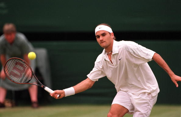 A young Roger Federer hits a volley at Wimbledon in 2001, the match where he upset Pete Sampras. Photo: Popperfoto/Getty Images