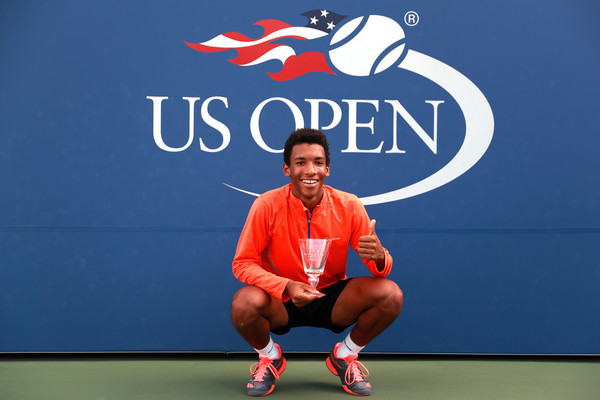 Félix Auger-Aliassime poses with the junior winner’s trophy after defeating Miomir Kecmanovic in the boys’ singles final of the 2016 U.S. Open. | Photo: Michael Reaves/Getty Images North America