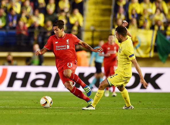 Roberto Firmino dribbles past Mario as the Brazilian looks to create a chance for Liverpool in the first leg of the Europa League semi-final. (Getty)