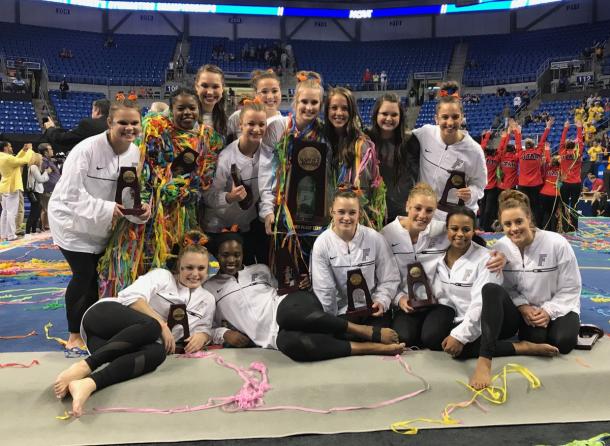 Florida celebrates the third place trophy. Photo Credit: Florida Gators Gymnastics Twitter.