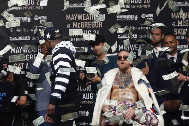 Mayweather threw money over McGregor in one of the more theatrical moments of their New York press conference (image: USA Today)