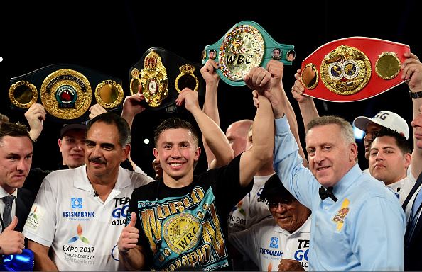 Gennady Golovkin of Kazakhstan poses with his belts after his second round TKO of Dominic Wade during a unified middleweight title fight | Harry How - Getty Images