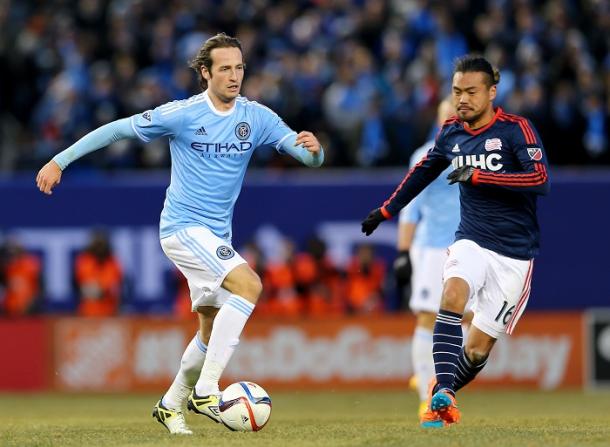 Mix Diskerud #10 of New York City FC takes the ball as Daigo Kobayashi #16 of New England Revolution defends during the inaugural game of the New York City FC at Yankee Stadium on March 15, 2015 in the Bronx borough of New York City.The New York City FC defeated the New England Revolution 2-0. (Photo by Elsa/Getty Images