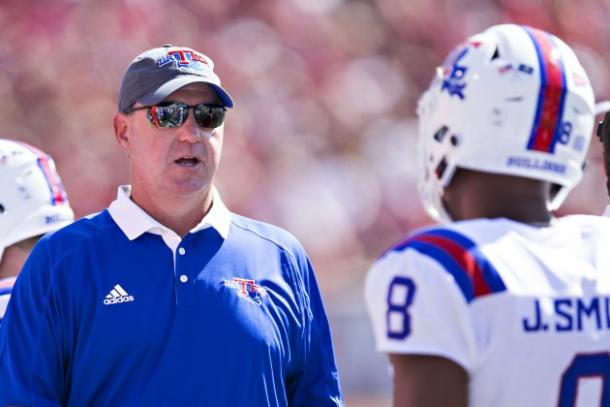 Louisiana Tech head coach Skip Holtz talks with players during a regular season game/Getty Images