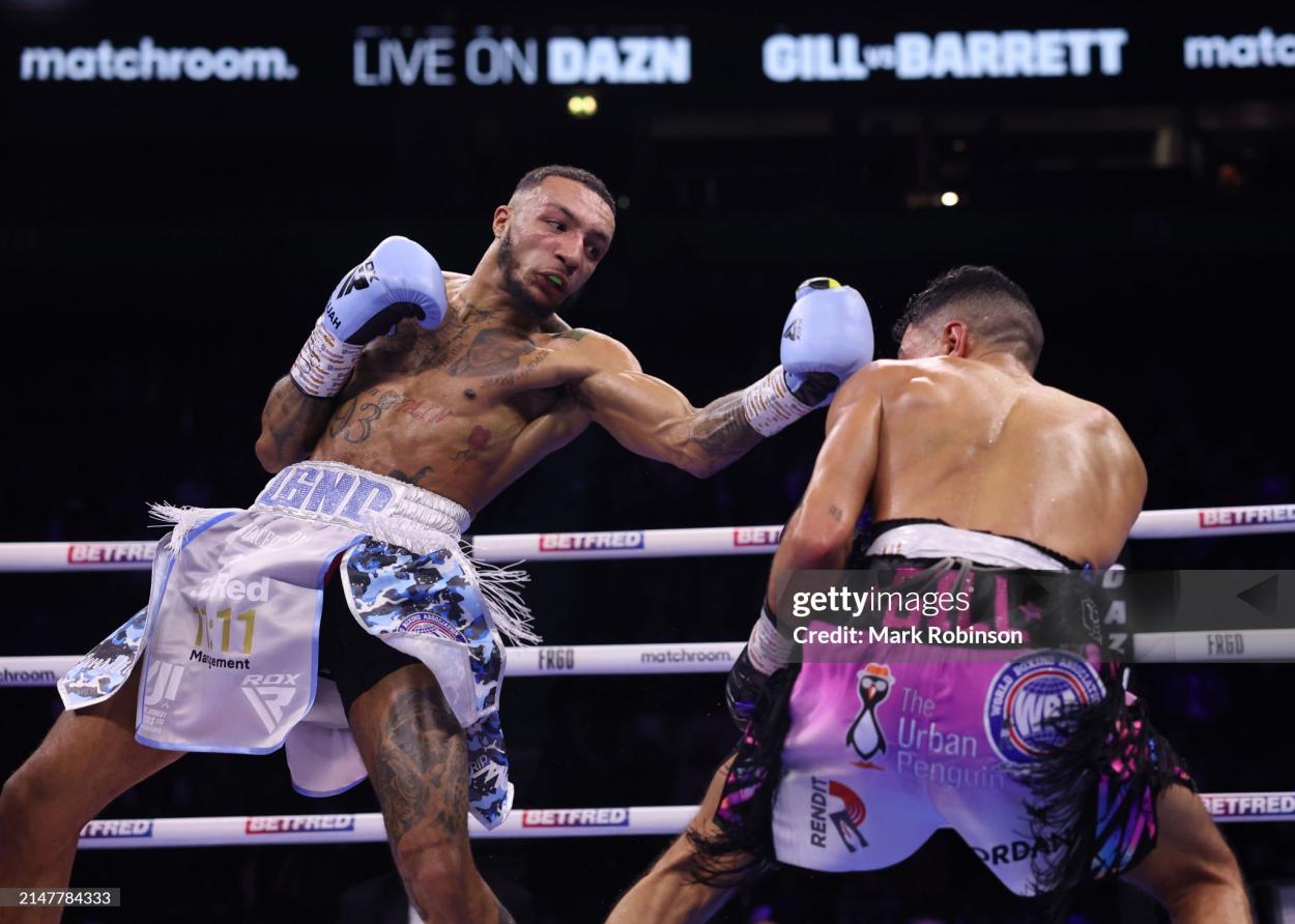 MANCHESTER, ENGLAND - APRIL 13: Jordan Gill (white and purple shorts) and Zelfa Barrett (white and blue shorts) during their WBA International Super Featherweight Title Contest at AO Arena on April 13, 2024 in Manchester, England. (Photo by Mark Robinson/Matchroom Boxing via Getty Images)