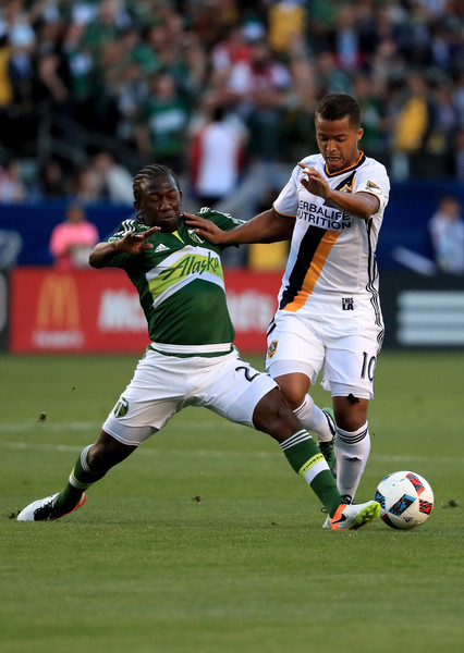 Giovani Dos Santos is challenged by Diego Chara Image Courtesy of Sean M. Haffey/Getty Images North America