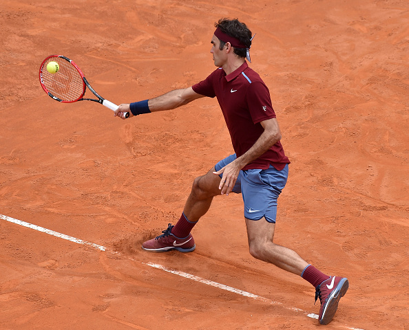 Federer slides into a forehand shot. Credit: Giuseppe Bellini/Getty Images