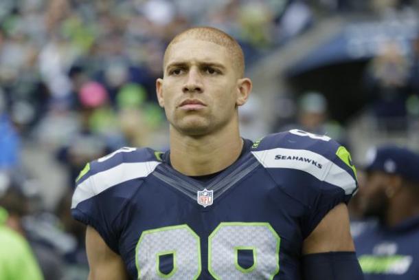Seattle Seahawks tight end Jimmy Graham looks on in an NFL game. Image via Elaine Thompson/AP