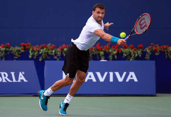 Grigor Dimitrov playing a backhand to Yuichi Sugita during their first-round match at the Rogers Cup/Photo: Vaughn Ridley/Getty Images
