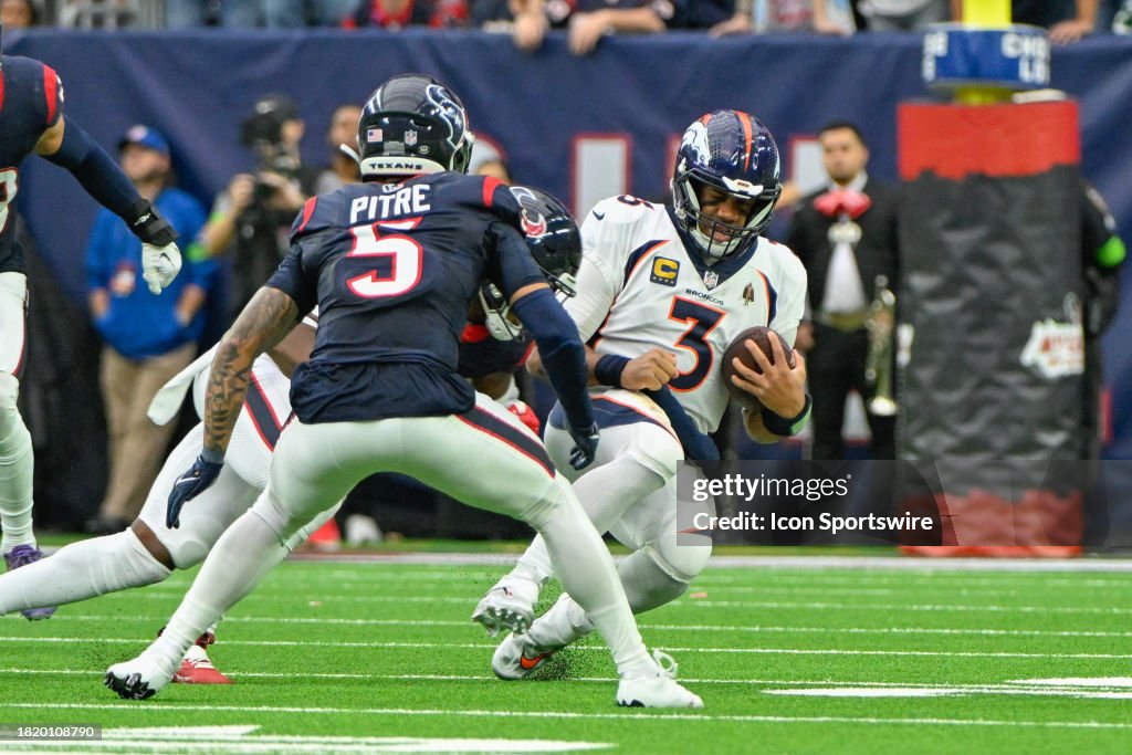  Denver Broncos quarterback Russell Wilson (3) slides as Houston Texans safety Jimmie Ward (1) prepares for a big hit during the football game between the Denver Broncos and Houston Texans at NRG Stadium on December 3, 2023 in Houston, Texas. (Photo by Ken Murray/Icon Sportswire via Getty Images)