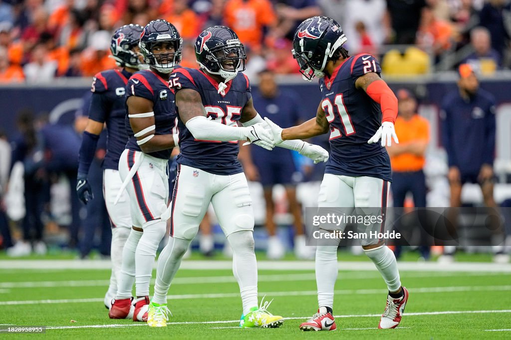 Grayland Arnold #25 and Steven Nelson #21 of the Houston Texans celebrate in the second quarter against the Denver Broncos at NRG Stadium on December 03, 2023 in Houston, Texas. (Photo by Sam Hodde/Getty Images)