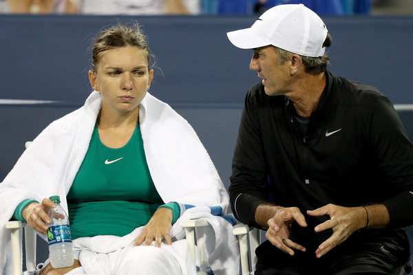 Halep talks to her coach Darren Cahill during the comeback victory. Photo: Matthew Stockman/Getty Images