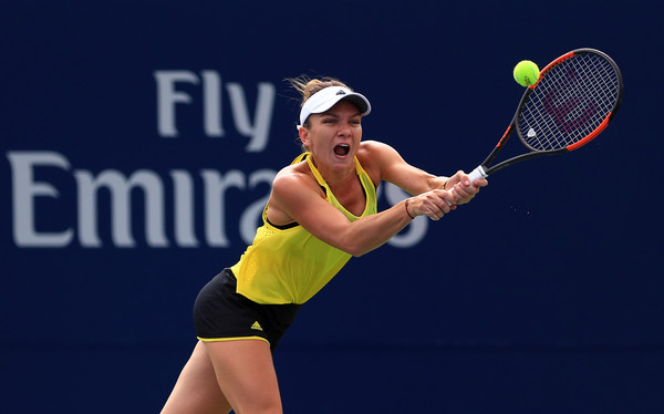 Halep awkwardly lunges for a backhand on Saturday in Toronto. Photo: Vaughn Ridley/Getty Images