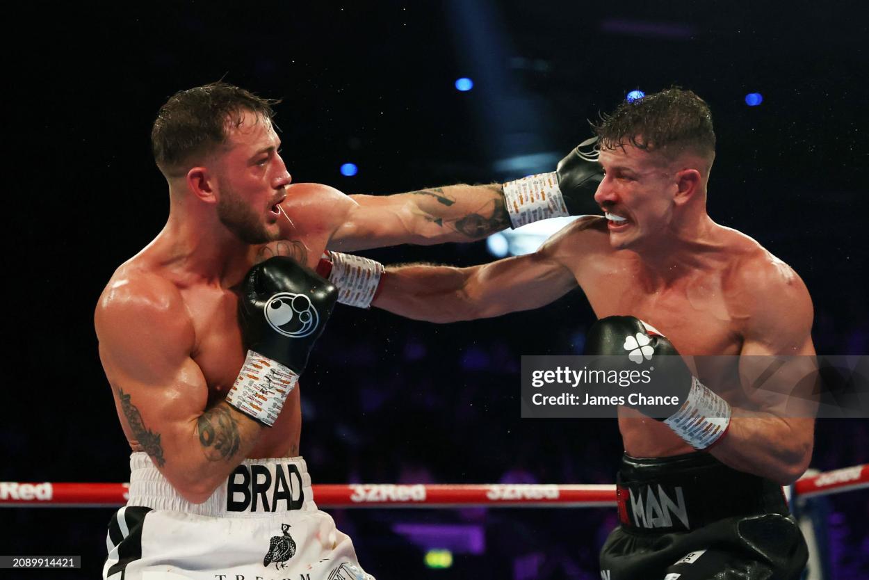 BIRMINGHAM, ENGLAND - MARCH 16: Brad Pauls and Nathan Heaney exchange punches during the British Middleweight Title fight between Nathan Heaney and Brad Pauls at Resorts World Arena on March 16, 2024 in Birmingham, England. (Photo by James Chance/Getty Images)