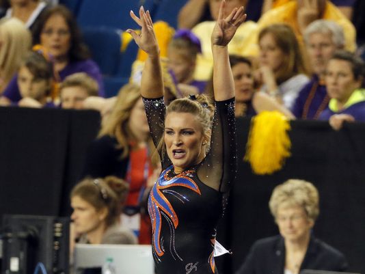 Bridget Sloan salutes after a stellar floor exercise at the NCAA Women's Gymnastics Championships/AP