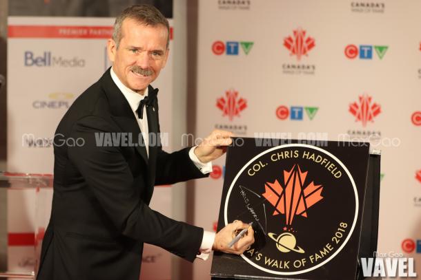 Say cheese! Chris Hadfield poses for a picture with his star on Canada’s Walk of Fame.