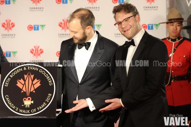 Seth Rogen humorously shows off his star while co-star Evan Goldberg takes a minute to admire their names literally etched in stone.