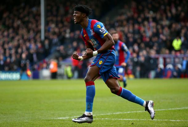 Zaha celebrates after his cross was deflected into the goal by Vertonghen 
