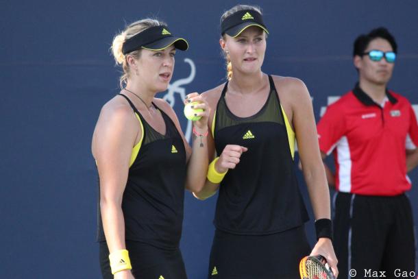 Anastasia Pavlyuchenkova (left) and Kristina Mladenovic discuss strategy before the former serves during their first-round match at the 2017 Rogers Cup presented by National Bank. | Photo: Max Gao