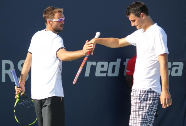 Viktor Troicki and Bernard Tomic high-five after winning a point during their first round doubles match against Félix Auger-Aliassime and Denis Shapovalov at the 2016 Rogers Cup. | Photo: Max Gao