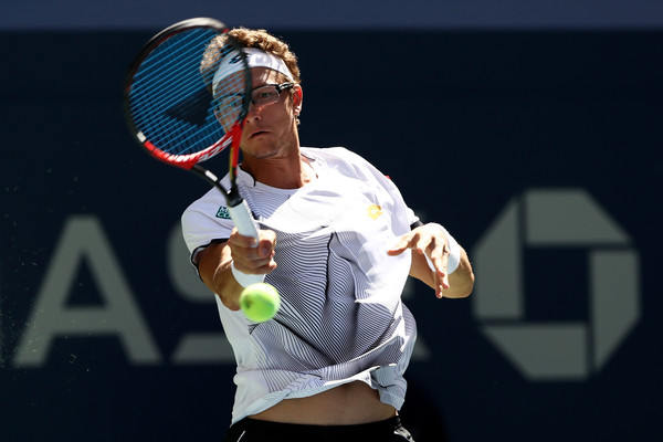 Denis Istomin hits a forehand during his first round loss. Photo: Elsa/Getty Images