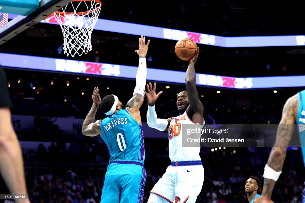 Julius Randle #30 of the New York Knicks shoots the ball over Miles Bridges #0 of the Charlotte Hornets during the first half of an NBA game at Spectrum Center on November 18, 2023 in Charlotte, North Carolina. NOTE TO USER: User expressly acknowledges and agrees that, by downloading and or using this photograph, User is consenting to the terms and conditions of the Getty Images License Agreement. (Photo by David Jensen/Getty Images)