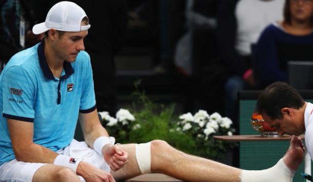 Photo: Dean Mouhtaropoulos/Getty Images-John Isner gets his left ankle taped.