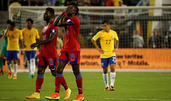 Haiti midfielder James Marcelin (in red, #14, right) celebrates after scoring a memorable goal against Brazil on Wednesday. Photo credit: Mike Ehrmann/Getty Images Sport