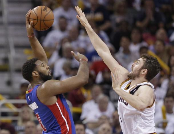 Detroit Pistons' Andre Drummond, left, shoots over Cleveland Cavaliers' Kevin Love in the first half in Game 2 of a first-round NBA basketball playoff series, Wednesday, April 20, 2016, in Cleveland. (AP Photo/Tony Dejak)