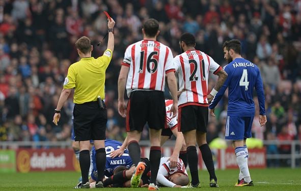 John Terry (left, on ground) of Chelsea is shown a red card by referee Mike Jones after fouling Wahbi Khazri of Sunderland | Gareth Copley - Getty Images