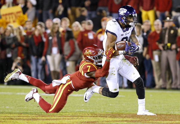 AMES, IA Ã¢ OCTOBER 17: Wide receiver Josh Doctson #9 of the TCU Horned Frogs is sacked by defensive back Qujuan Floyd #7 of the Iowa State Cyclones as he rushed for yards in the first half of play at Jack Trice Stadium on October 17, 2015 in Ames, Iowa. (Oct. 16, 2015 - Source: David Purdy/Getty Images North America)