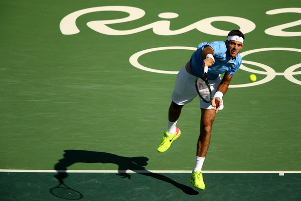 Juan Martin Del Potro hits a serve to Rafael Nadal during their semifinal match at the Olympics/Photo: Clive Brunskill/Getty Images