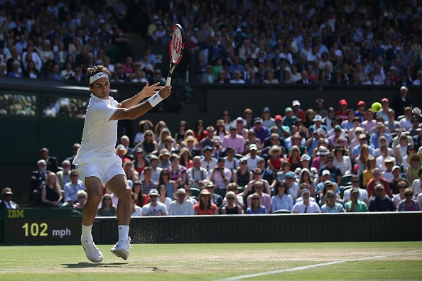 Federer rips a forehand on the run, hitting the crosscourt winner. Credit: Justin Tallis/Getty Images