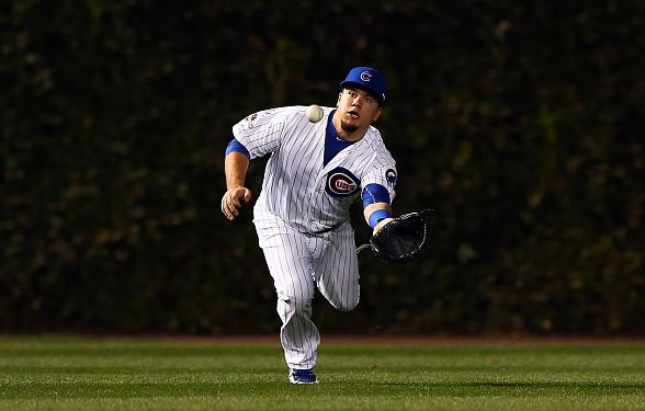 Kyle Schwarber #12 of the Chicago Cubs misses a catch hit by Wilmer Flores #4 of the New York Mets in the first inning during game four of the 2015 MLB National League Championship Series at Wrigley Field on October 21, 2015 in Chicago, Illinois. (Photo by Elsa/Getty Images