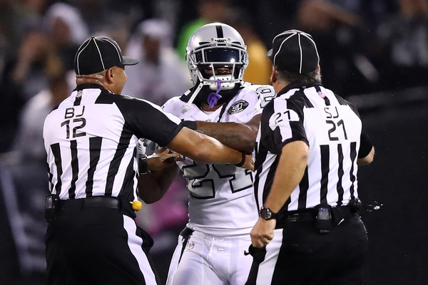 Marshawn Lynch #24 of the Oakland Raiders is restrained after coming off the bench and shoving a referee during a scrum with the Kansas City Chiefs. Lynch was ejected for unsportsmanlike conduct. |Source: Ezra Shaw/Getty Images North America|