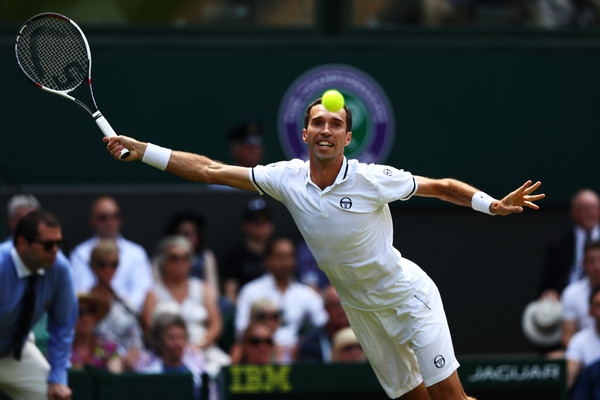 Mikhail Kukushkin lunges for a forehand during his second-round match at Wimbledon. Photo: Michael Steele/Getty Images