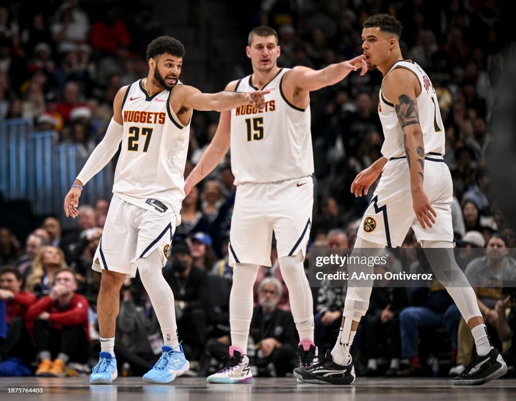 Jamal Murray (27) and Nikola Jokic (15) of the Denver Nuggets direct teammate Michael Porter Jr. (1) where to be on defenses against the Golden State Warriors during the fourth quarter of the Nuggets' 120-114 win at Ball Arena in Denver on Monday, December 25, 2023. (Photo by AAron Ontiveroz/The Denver Post)