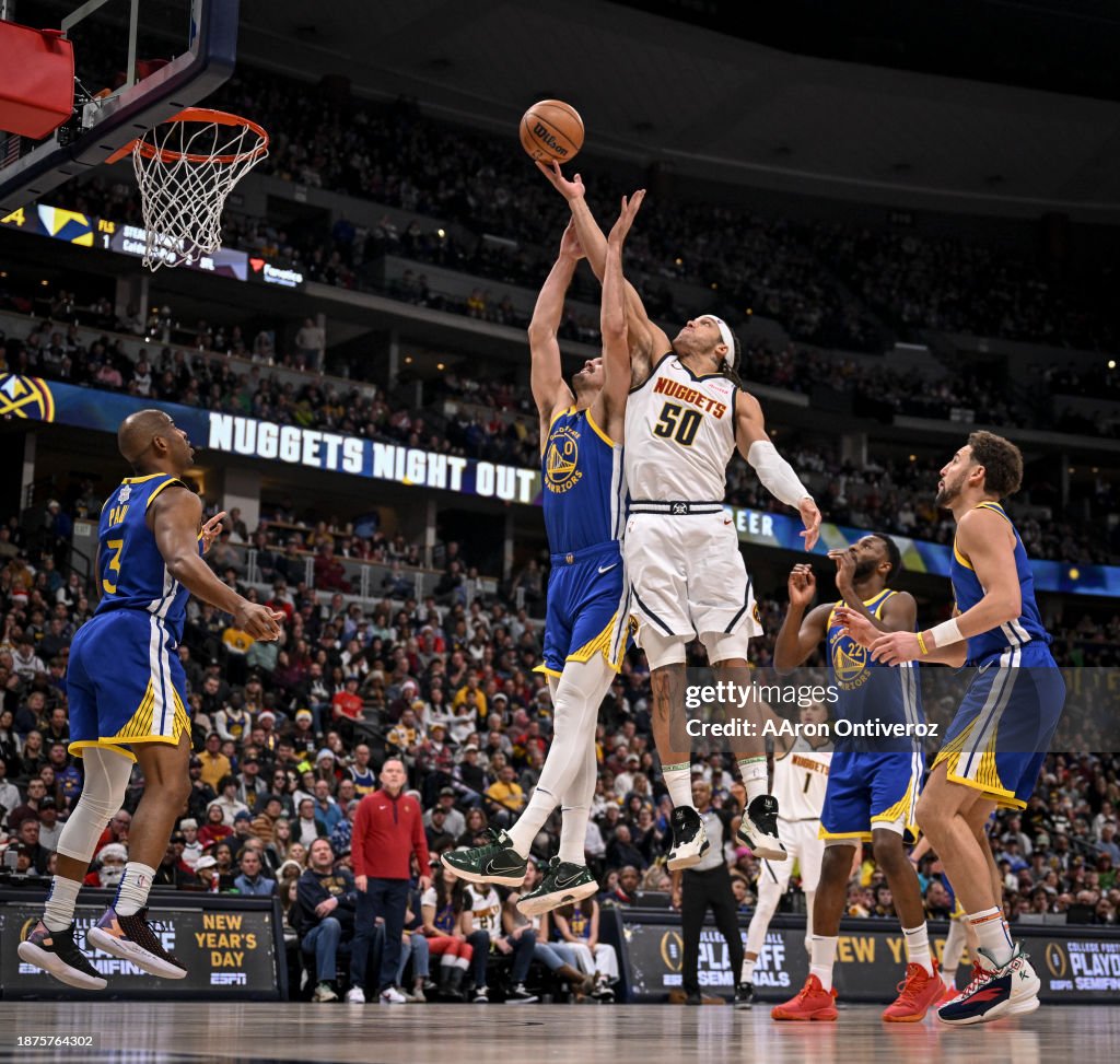 Dario Saric (20) of the Golden State Warriors bodies Aaron Gordon (50) of the Denver Nuggets out of the way as they fight for a rebound during the fourth quarter of the Nuggets' 120-114 win at Ball Arena in Denver on Monday, December 25, 2023. (Photo by AAron Ontiveroz/The Denver Post)