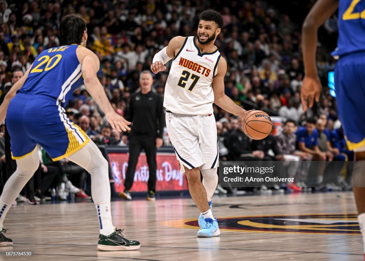 Jamal Murray (27) of the Denver Nuggets works as Dario Saric (20) of the Golden State Warriors defends during the fourth quarter of the Nuggets' 120-114 win at Ball Arena in Denver on Monday, December 25, 2023. (Photo by AAron Ontiveroz/The Denver Post)