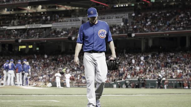 John Lackey walks to the dugout after being pulled from the game on Saturday in Cincinnati (AP)