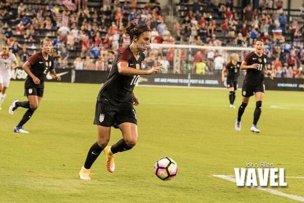 Carli Lloyd (center) setting up for a shot during a USWNT game | Source John Allen