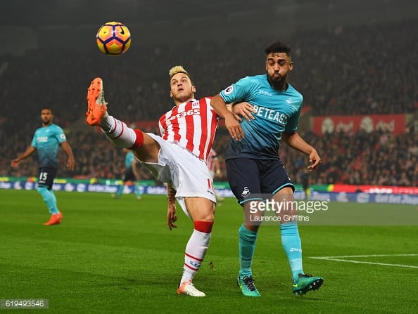 Marko Arnautovic battles with Neil Taylor during the Premier League match between Stoke City and Swansea City. |  Photo: Laurence Griffiths/Getty Images