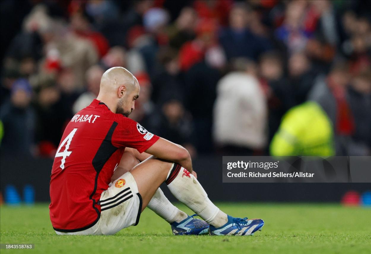 Sofyan Amrabat of Manchester United is dejected after the UEFA Champions League match between Manchester United and FC Bayern Munchen at Old Trafford on December 12, 2023 in Manchester, England. (Photo by Richard Sellers/Sportsphoto/Allstar via Getty Images)